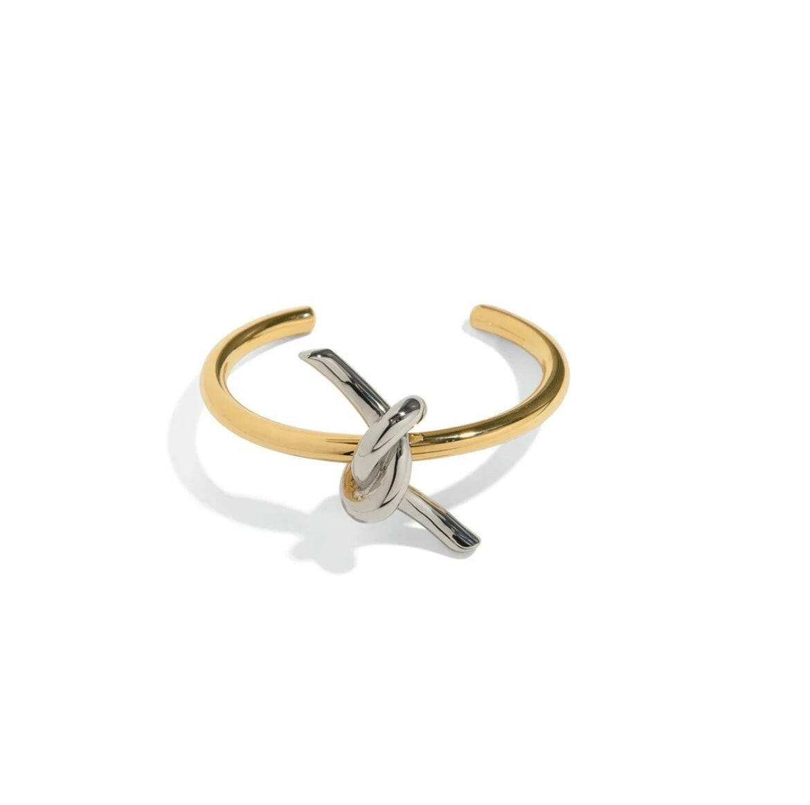 Elevate your style with our SOULMATE BRACELET. This cuff bracelet features a symbolic knot design. With its elegant and timeless appeal, it will effortlessly complement any outfit, making it an essential piece for every fashion-forward individual.
Elevate your look and embody the bond of true love with our SOULMATE BRACELET.
Material: 100% BRASS and 18K gold plated
Measurements: 2.40 x 2.50 in