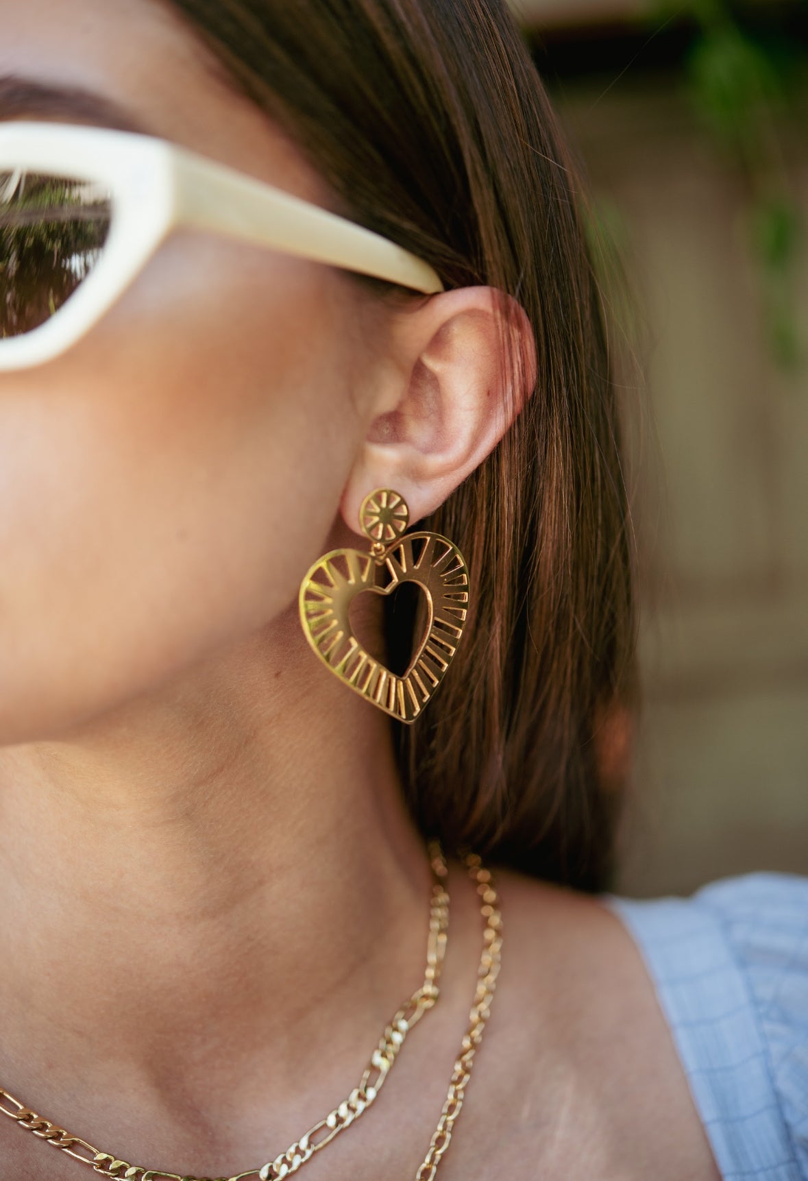 Model wearing bold gold heart earrings
Striped texture gold heart statement earrings
Lightweight heart earrings for bold looks