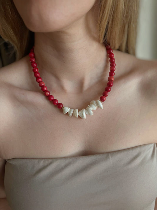 Red coral shell pendant necklace worn on neckline