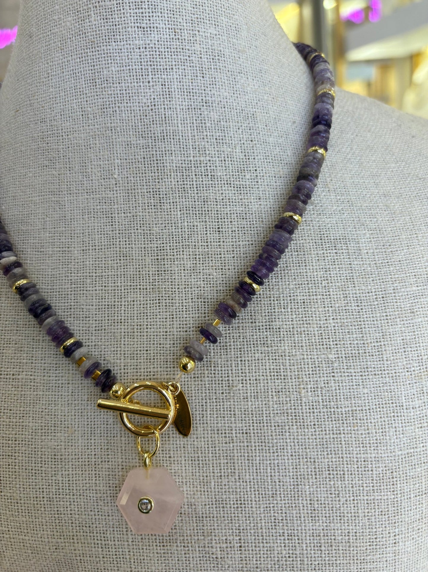 Amethyst and rose quartz beaded necklace worn on neckline