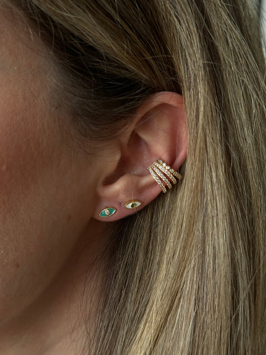 Protect yourself from negative energy and bring some edge to your look with our ENAMEL EVIL EYE BLUE STUDS!
These stylish studs are not only trendy, but they also serve as a powerful symbol of protection.
Add some attitude to your style and keep the bad vibes away with these eye-catching earrings.
Material: 925 Sterling Silver + gold plated 18K
Measurements: .3 in x .15 in