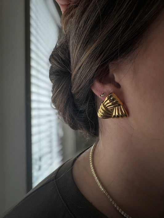 Gold Amelie chunky triangle earrings worn on ear