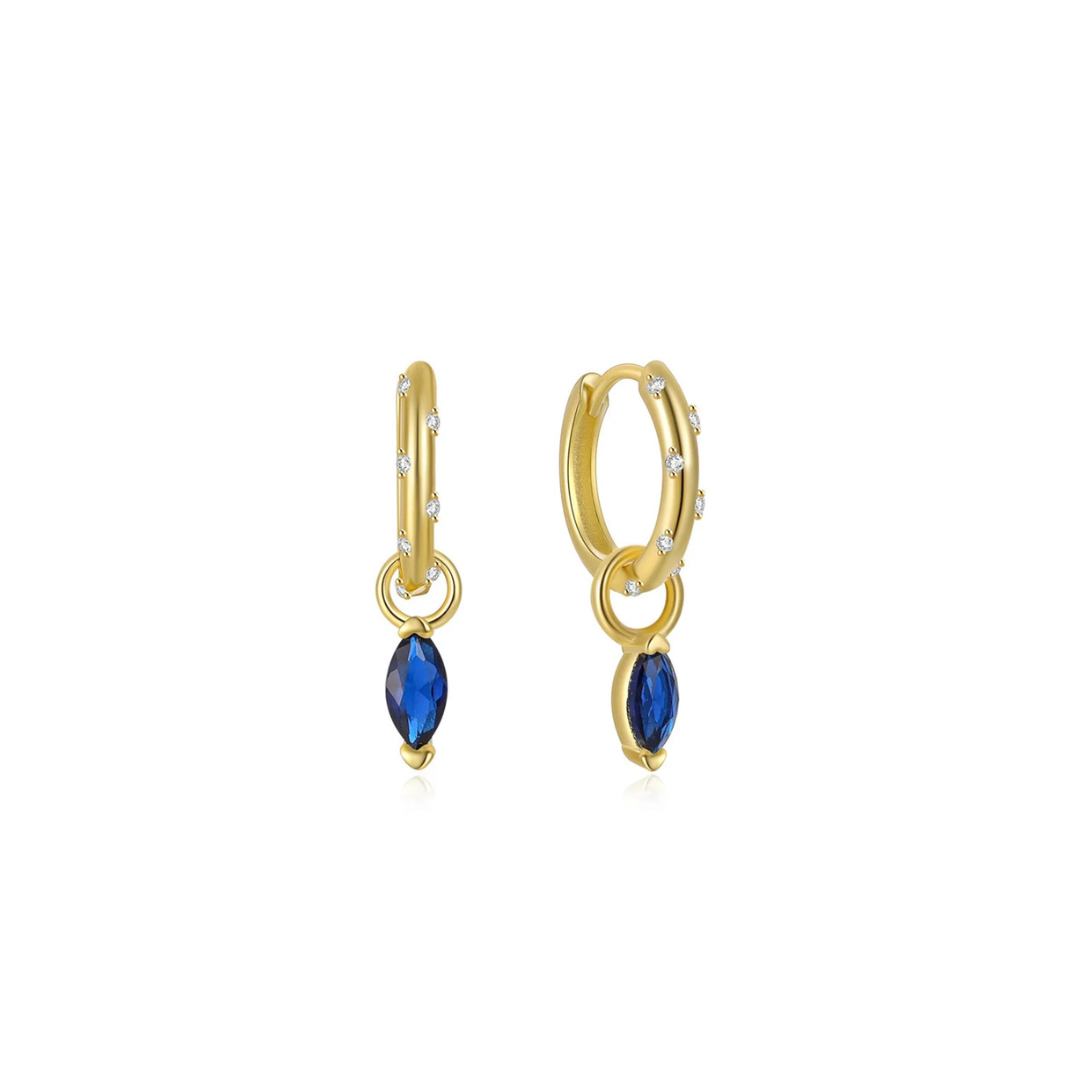 Add a touch of sparkle to your look with these charming blue hoops. The oval shape adds a unique twist, while the blue charm enhances any outfit. Perfect for the fashion-forward and the playful at heart.
Material: .925 Sterling Silver + 14K gold plated
Measurements: .50 in x .50 in
pendant: .25 in x .25 in