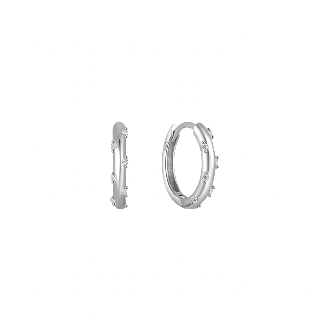These playful hoops are sure to brighten up any outfit and put a smile on your face.
The combination of the silver color and the clear stone creates a harmonious and eye-catching piece, suitable for both casual and more formal occasions.
Material: .925 Sterling Silver + 18K gold plated
Measurements: .55 in diameter