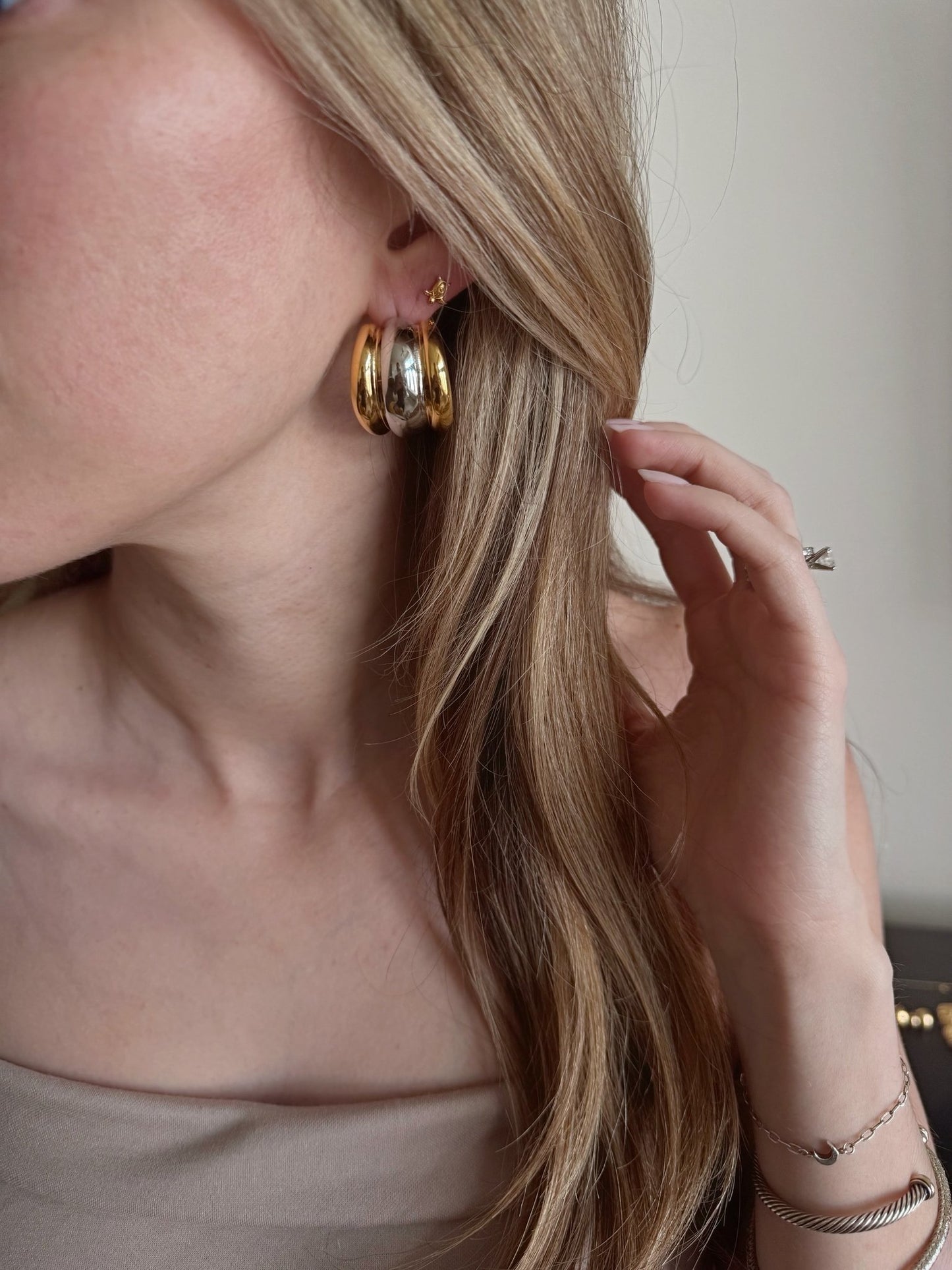 The Merge triple hoops worn on ear showing bicolor effect