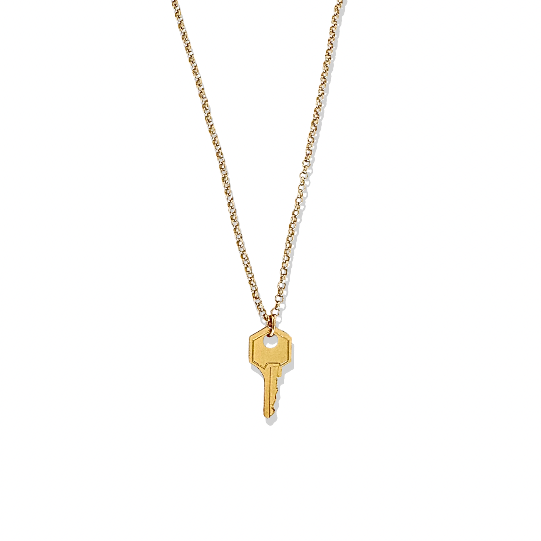 Unlock timeless style with this gold key pendant necklace. Suspended on a fine gold chain, the key charm symbolizes opportunity and new beginnings, making it a meaningful and stylish accessory.
