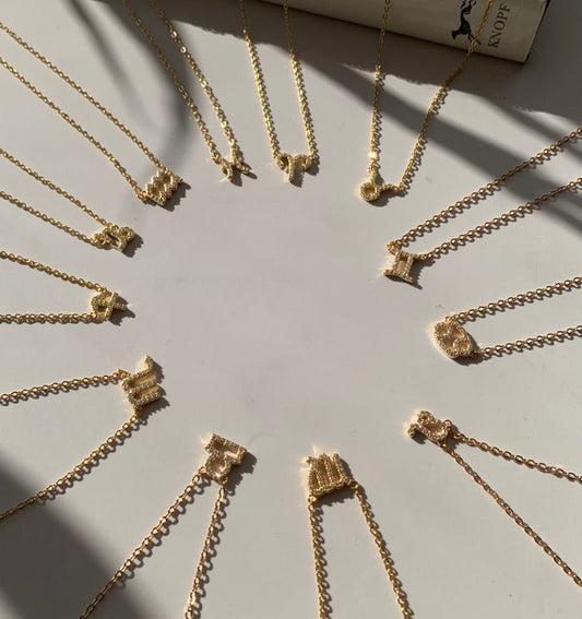 Sagittarius zodiac necklace layered with gold chain necklaces