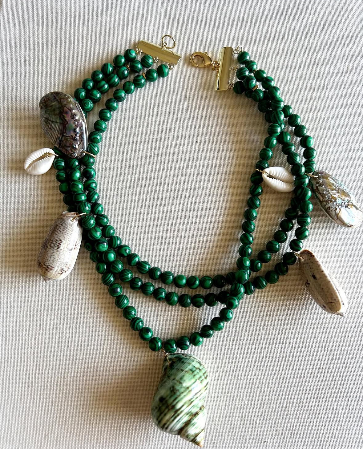 Feel radiant in beach-inspired gold jewelry. The Sunkissed Collection features crystals, pearls, and shells for your sun-drenched summer glow.