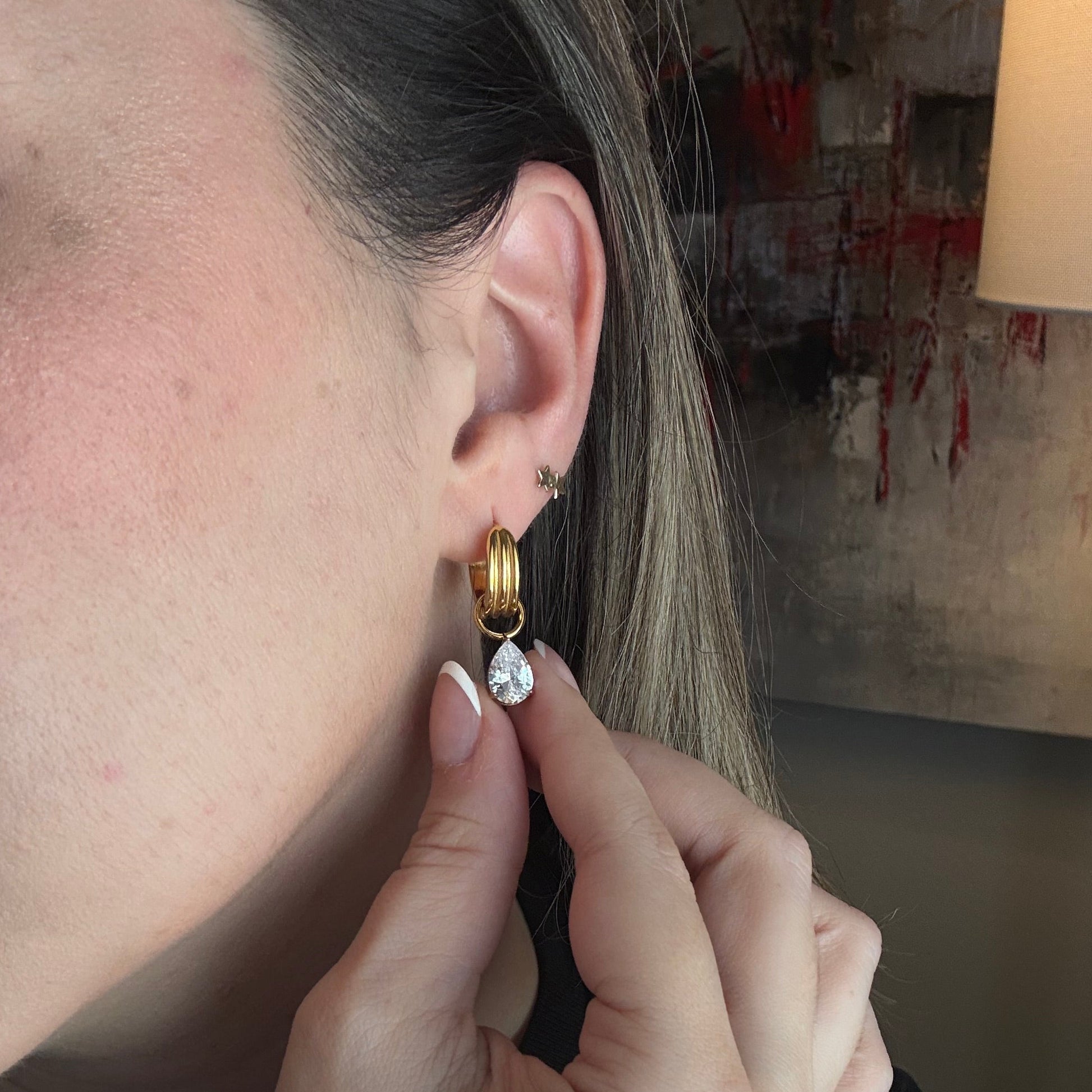 Brooke drop zircon huggie hoop earrings worn on ear