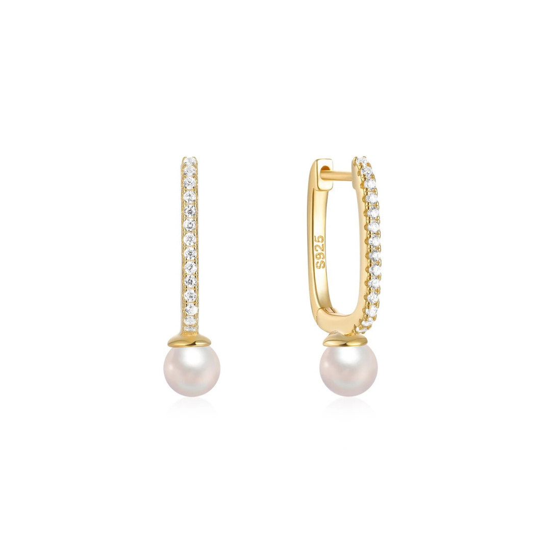 Add a touch of elegance with these must-have OVAL DROP PEARL GOLDEN HOOPS. 
These hoops feature a stunning oval drop design and shimmering pearl detail.

Perfect for any occasion, elevate your style with these versatile and playful hoops. 


Material: .925 Sterling Silver + 18K gold plated

Measurements: .75 x .45 in