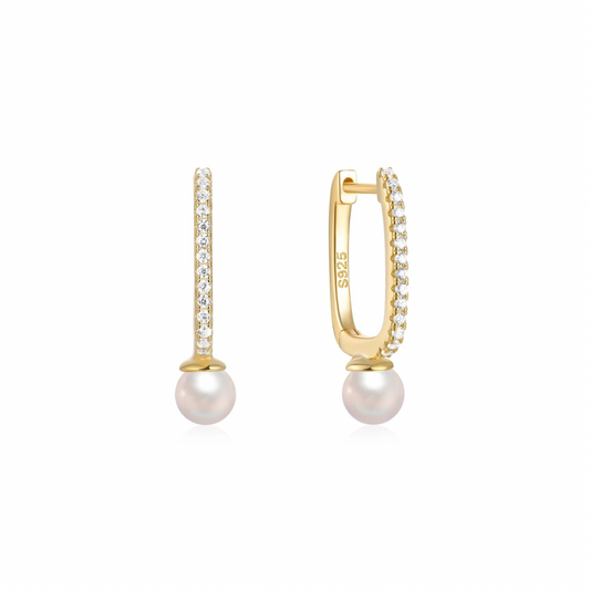 Add a touch of elegance with these must-have OVAL DROP PEARL GOLDEN HOOPS. 
These hoops feature a stunning oval drop design and shimmering pearl detail.

Perfect for any occasion, elevate your style with these versatile and playful hoops. 


Material: .925 Sterling Silver + 18K gold plated

Measurements: .75 x .45 in