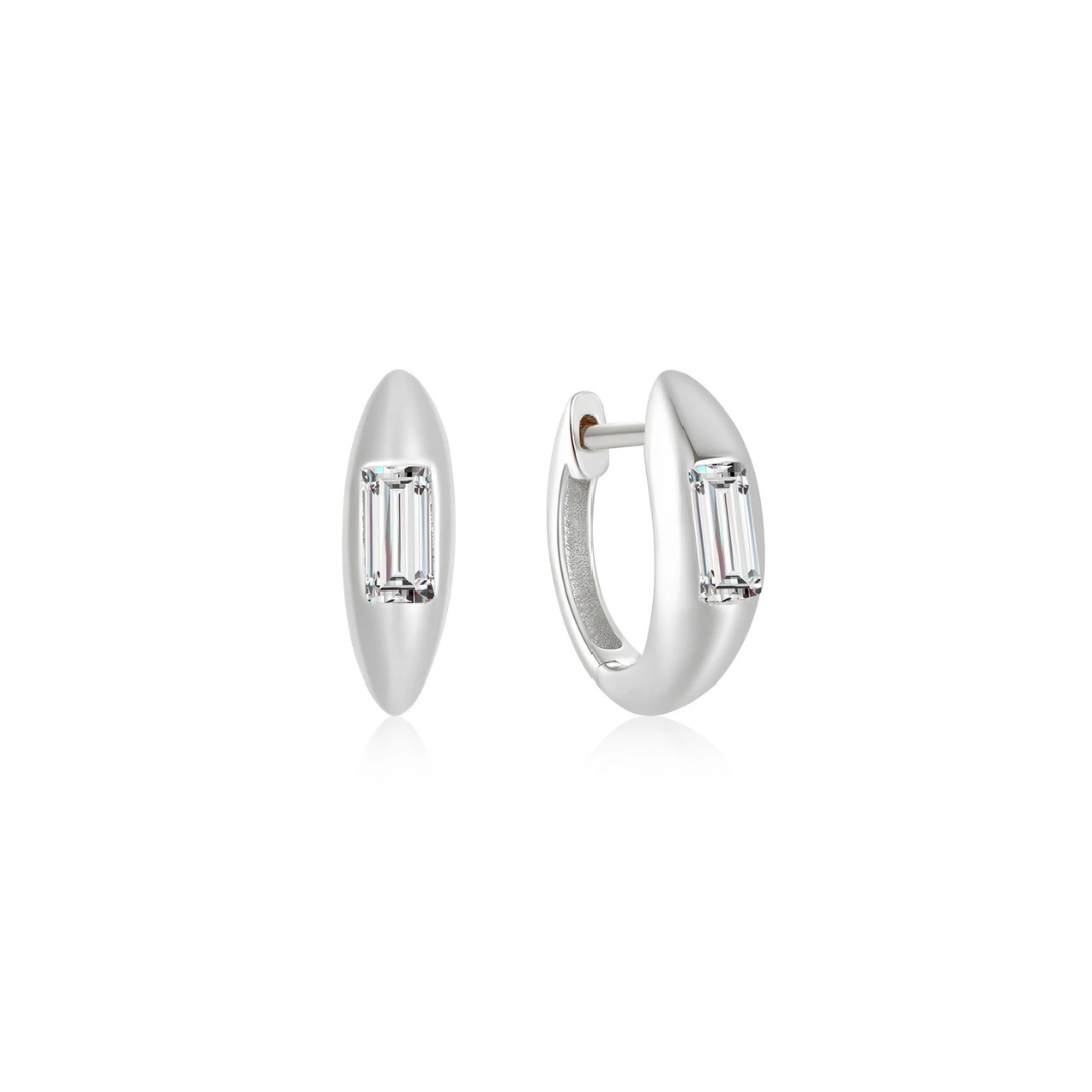 Introducing our Silver Glimmer Hoops, featuring stunning small emerald-cut diamonds.

These elegantly designed hoops are sure to add a touch of glamour to any outfit. With their sleek and modern style, these hoops are perfect for any occasion.

Material: .925 Sterling Silver + 18K gold plated