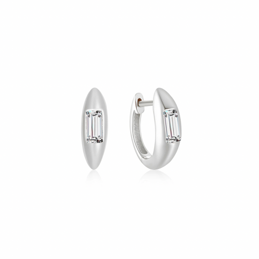 Introducing our Silver Glimmer Hoops, featuring stunning small emerald-cut diamonds.

These elegantly designed hoops are sure to add a touch of glamour to any outfit. With their sleek and modern style, these hoops are perfect for any occasion.

Material: .925 Sterling Silver + 18K gold plated