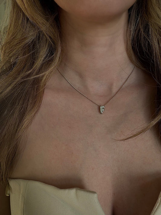Initial silver bubble letter necklace worn layered
