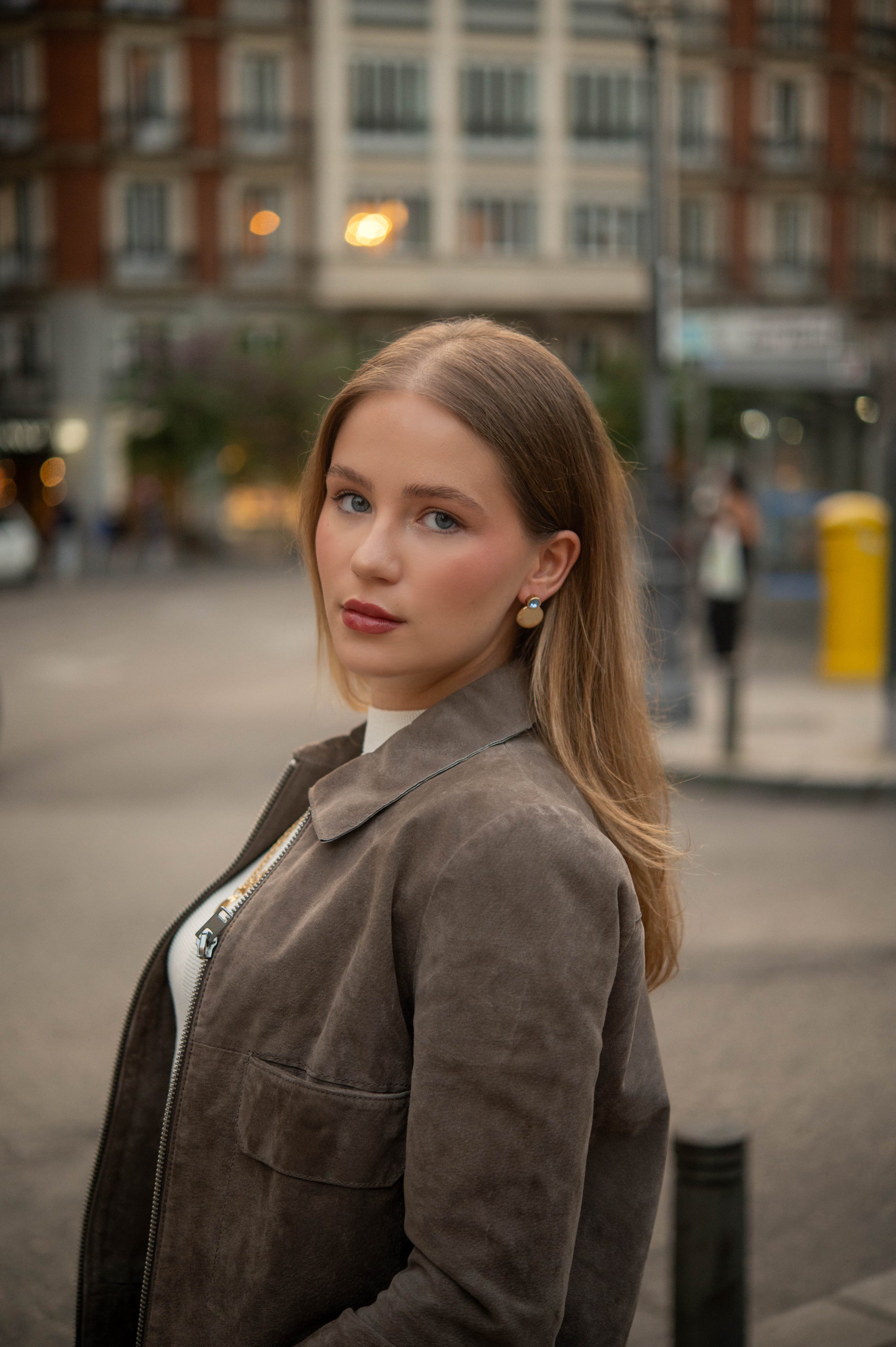 Nerea baby blue earrings worn on ear, statement look