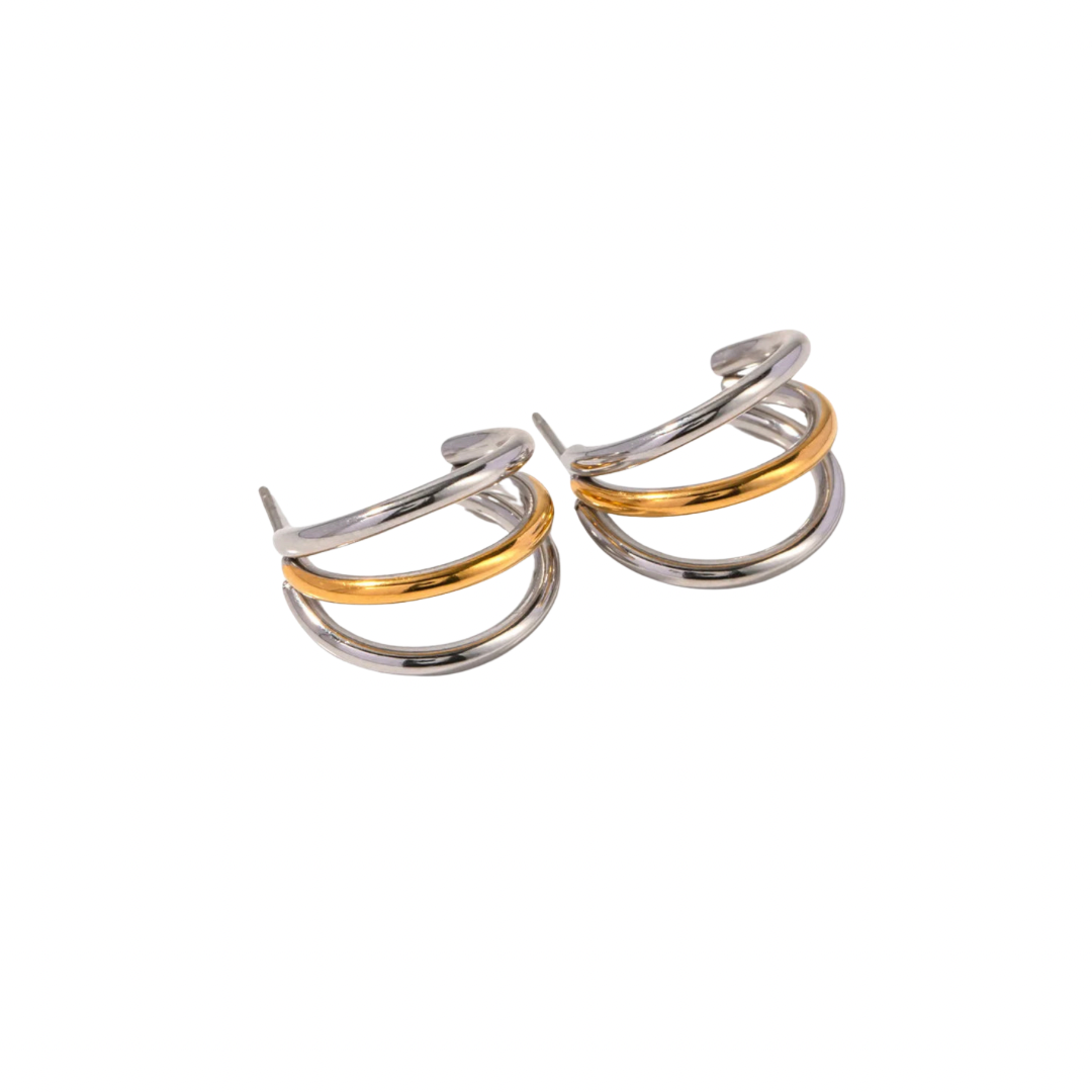 Expertly crafted with three interlocking hoops, the DUAL COLOR TRIPLE HOOPS add a modern twist to a classic design. The contrasting colors create a unique and eye-catching look, perfect for any style. Made with quality and precision, these hoops are a must-have for any jewelry collection.