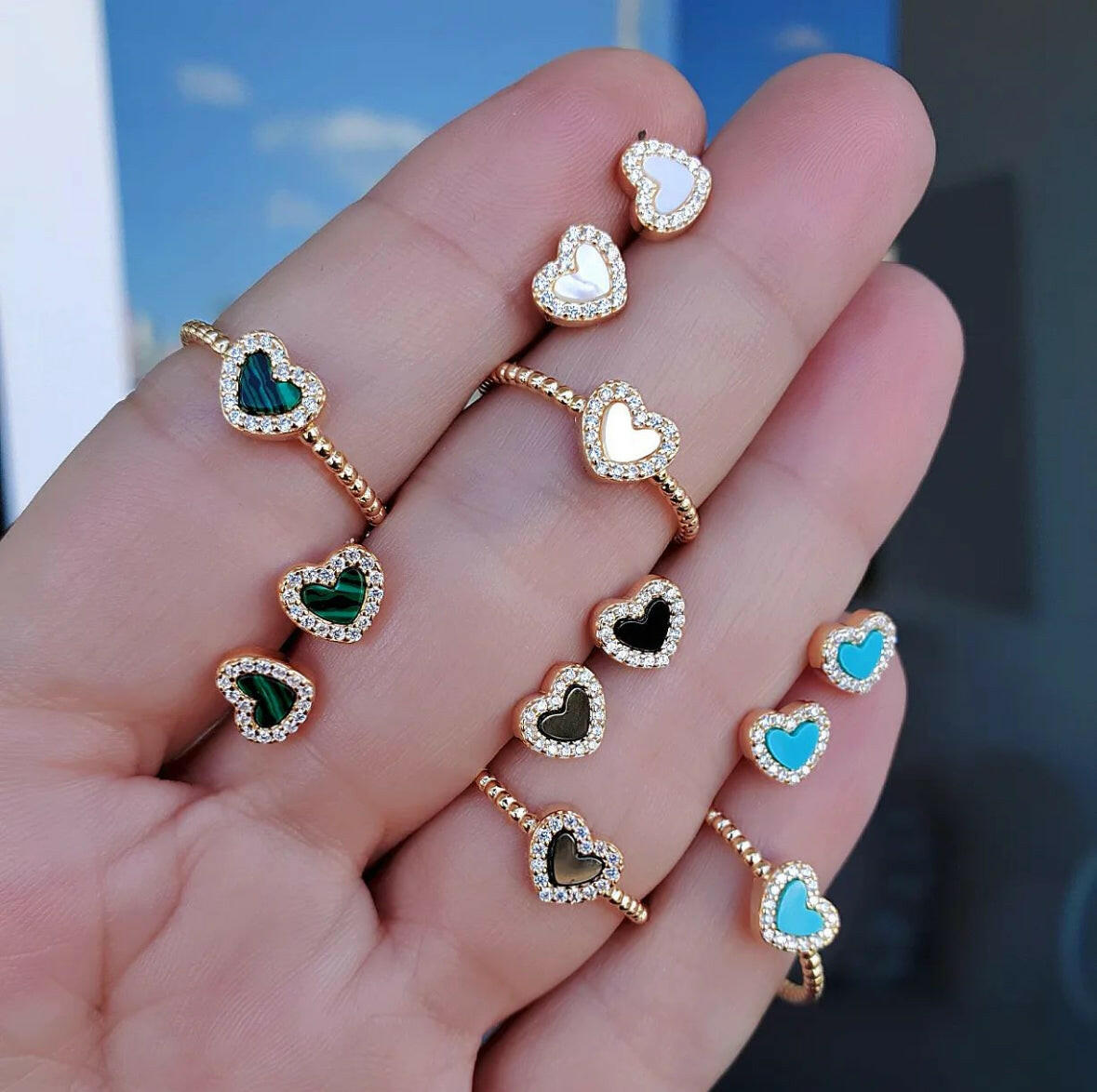 Gold heart ring with black onyx stone worn on hand