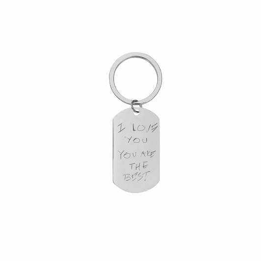 A rectangular silver keychain with engraved text 'I love you you are the best' on a white background.