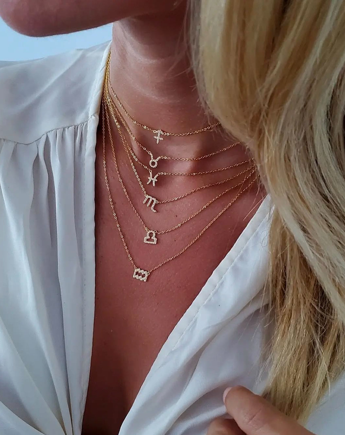 Taurus gold zodiac necklace worn on neckline, 18 inch chain