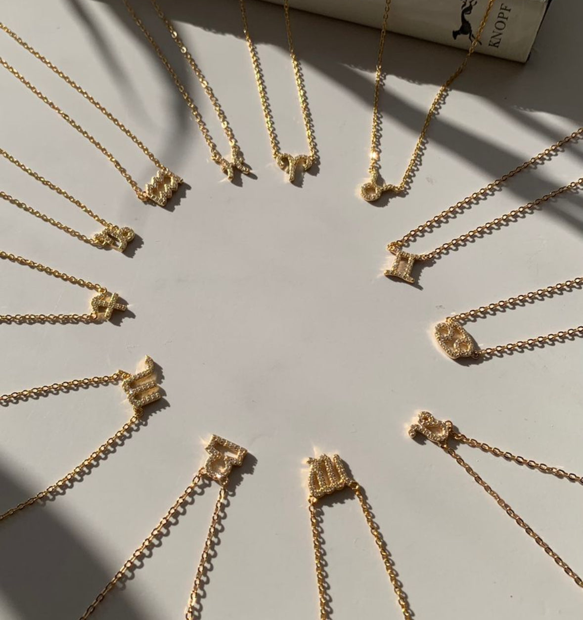Taurus zodiac necklace layered with gold chain necklaces